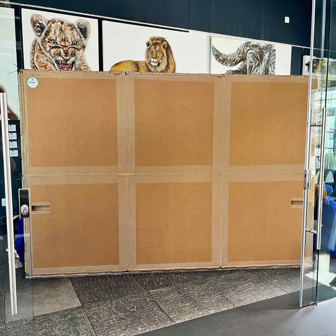 Large custom art packaging crate in front of animal paintings