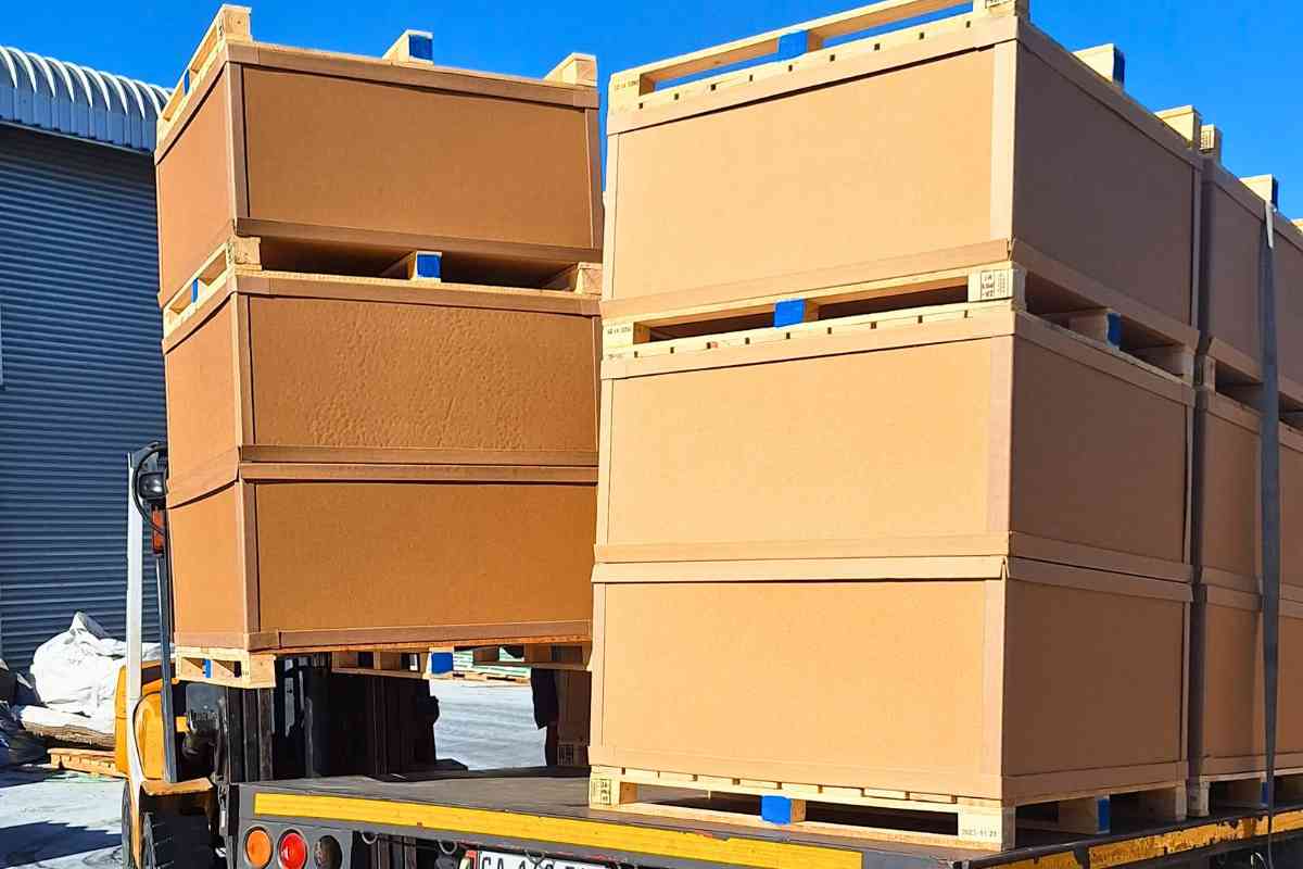 Stacked flat-packable interlock pallet boxes with timber pallets, designed for secure shipping, easy assembly, and efficient storage.