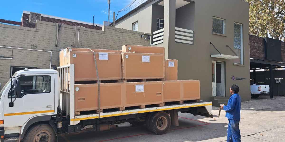 Large industrial machinery packed in custom crates and loaded onto a transport truck