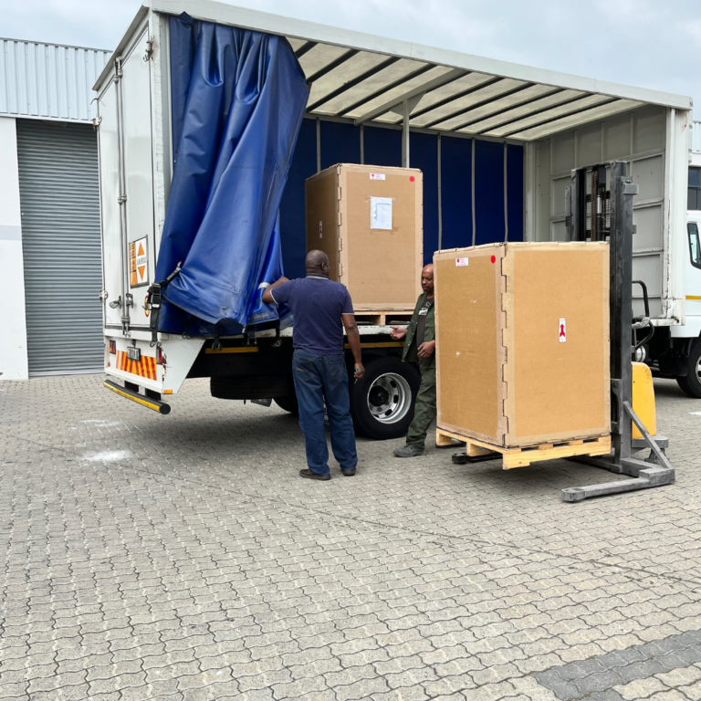 Export crate being loaded for heavy machinery transport