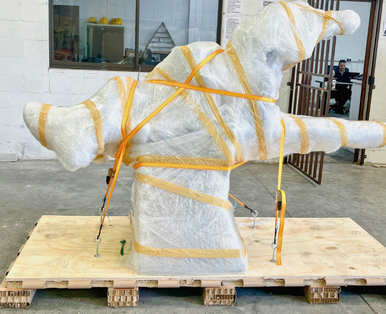 Wrapped artwork secured on a custom paper pallet