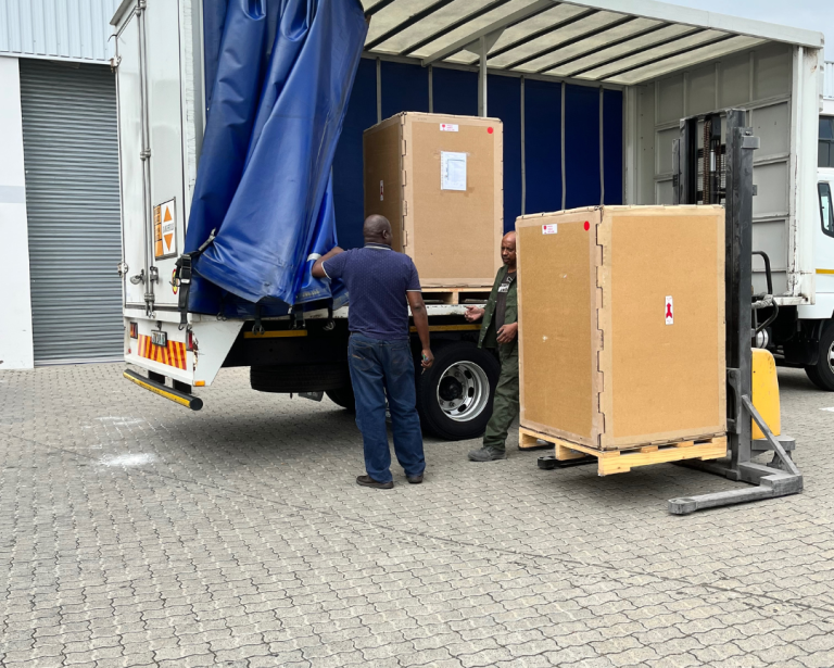 Export crate being loaded for heavy machinery transport